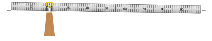 The beam balance apparatus with the beam tilted slightly down and to the right.