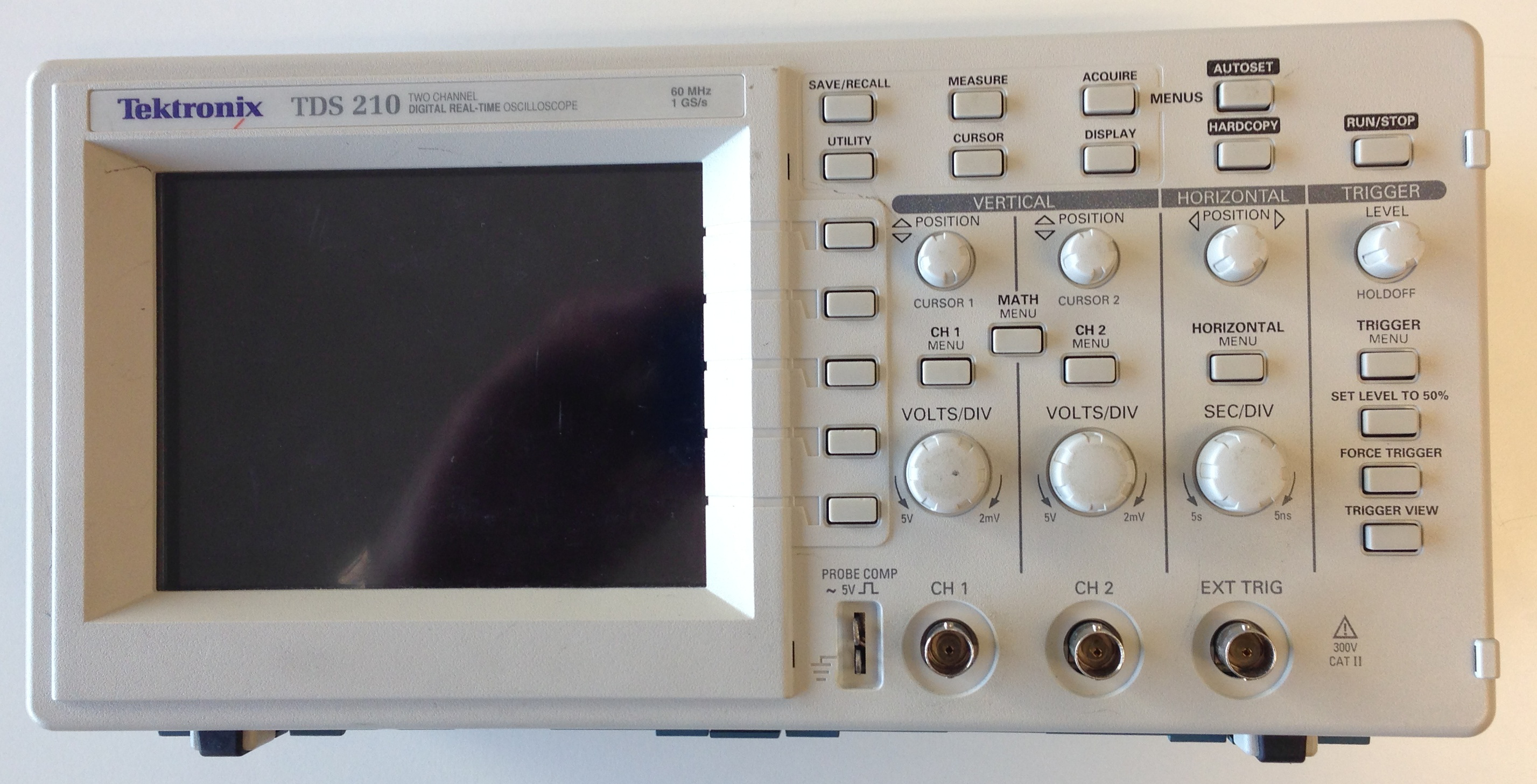 This is an image of the front side of the oscilloscope. It has a screen and various knobs and input channels.